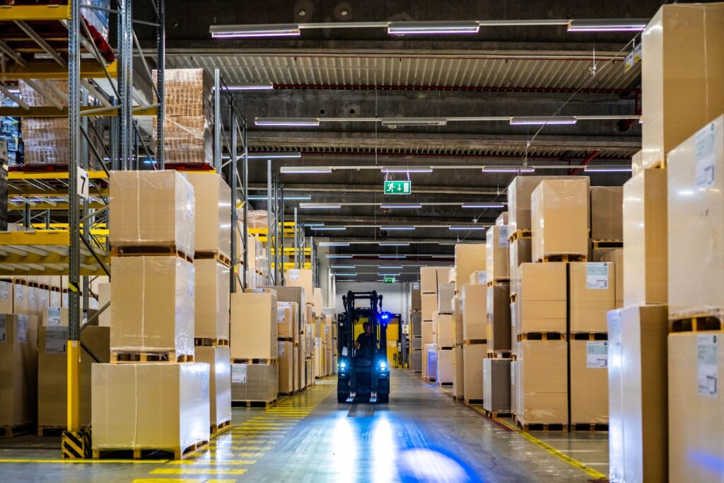 Warehouse worker driving forklift