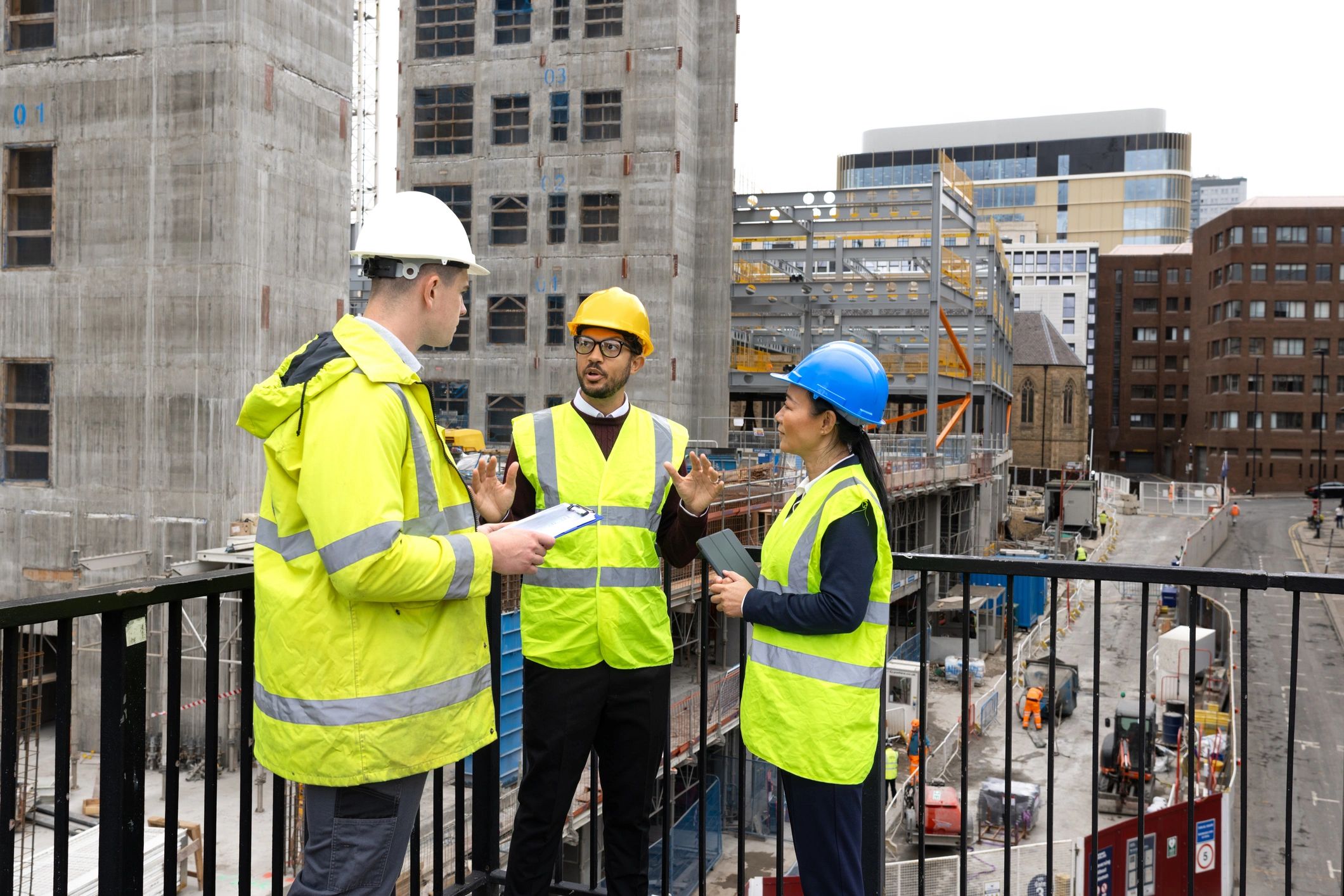 Construction safety team reviewing plans in hard hats