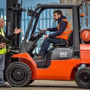 Forklift driver and coworker in safety vests
